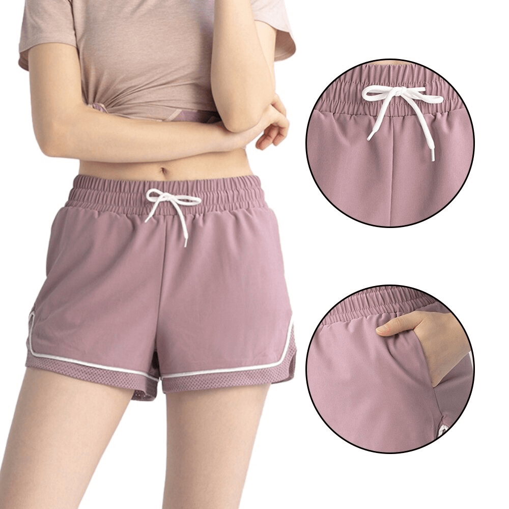 Pink workout shorts with adjustable drawstring for women, featuring quick-dry fabric and side pockets. Ideal for yoga or fitness.